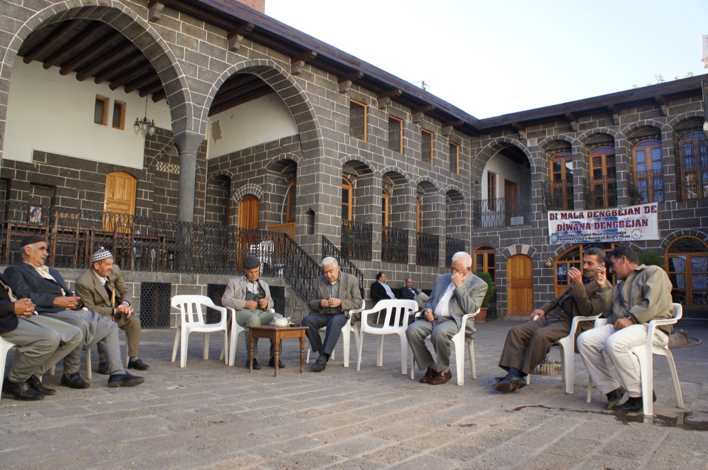 Dengbêj singers gathered in the basalt courtyard of the Dengbêj House, Amed (Diyarbakır)